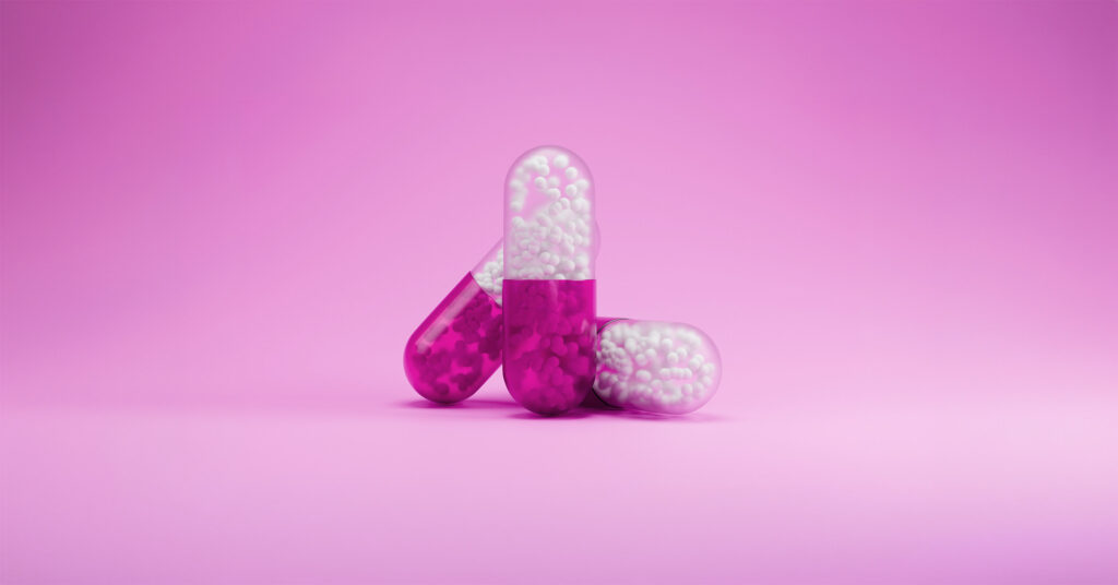 Prescription medication capsules representing drug affordability programs, patient access solutions, copay assistance, and financial support services that help patients start and stay on prescribed therapies.