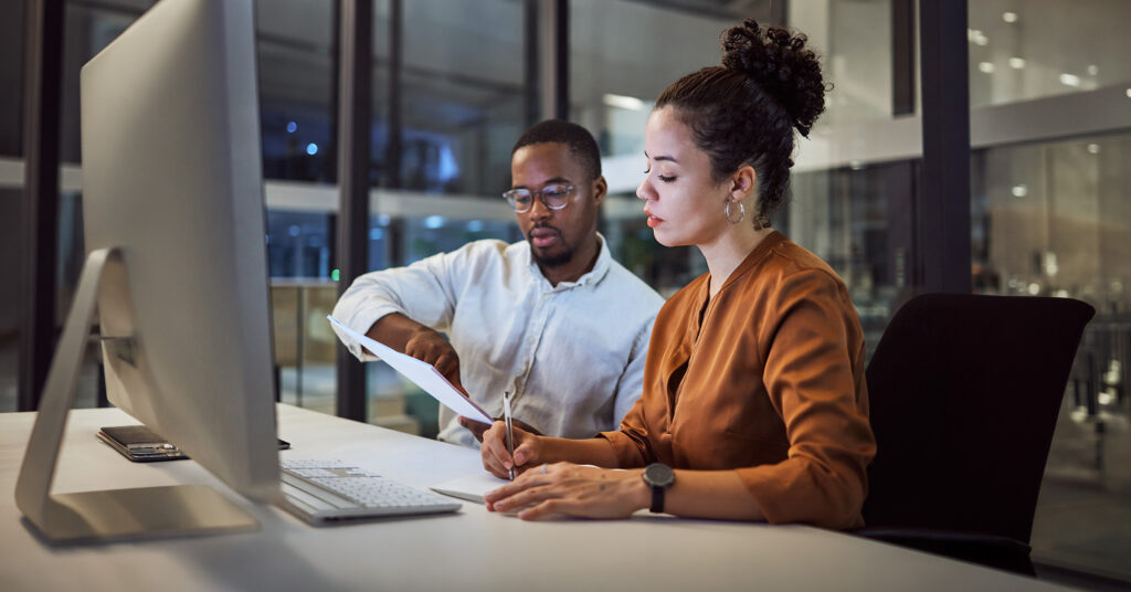 Pharmaceutical support specialists collaborating on patient services strategy, leveraging technology and data-driven engagement solutions to improve patient access, adherence, and healthcare outcomes.